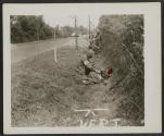 [Sgt. Dewitt Blunt, Vandalia, Ill., first aid man, gives assistance to an American soldier injured by a shrapnel burst near Coudray in the drive to Angers, France.]