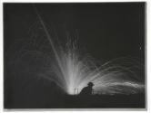 [Explosion at night, with soldier in foreground]