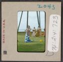 [Hula dancer and musicians, Hawaii (travel slide)]