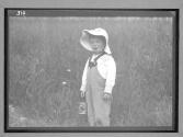 Boy with Pail in Field