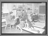 [Teacher reading to Children]