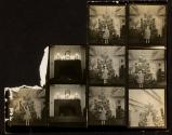 [Girl with Christmas tree and decorated mantle, contact sheet]