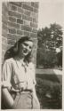 [Joan Martin leaning against Brick Wall]