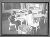 [Two Children Sewing]