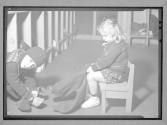 [Two Children Putting on Winter Clothes]