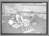 [Three Children with Blocks]