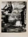 Linen on clothespole flaps against funeral sculpture