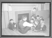[Children by Fireplace]