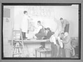 [Young Men Hanging Artwork]