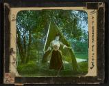 [Woman in woods with flag]