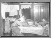 Picking Nut Meats With Dirty Baby In Lap...New York City 1911