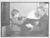 Violin Lesson, Refugee From Russia His Talent Fostered/ 1910