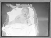 Slums Chicago, An Infant with TB crying in Basket