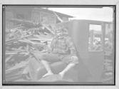 [Boy Sitting in Junk Car]