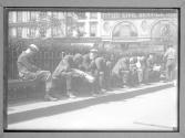 A Line up of the Jobless city men on a Park Bench