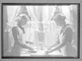 [Two girl scouts making cookies]