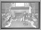 [Girl Scouts by fireplace]