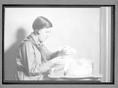 [Girl Scout making stuffed toy]
