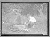 [Girl making fire in grill]