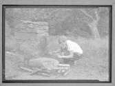 [Girl Scout near outdoor fireplace]