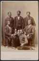[Six men around a table]