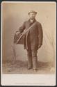 [Man holding box labelled 'Confectionery']