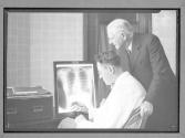 [Two Men Examine X'Rays]