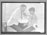 Doctor Examining Young Boy in Clinic