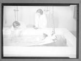[Women, Child in Therapy Bath]
