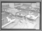 [Children in Hospital Cots]