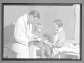 [Doctor Taking Bandage off Child]
