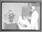 [Nurse with Mother of Newborn]