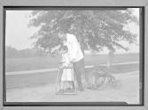 [Child in Walker with Doctor]
