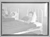 [Boy in Institutional Bed]