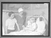 [Child in Hospital Bed]