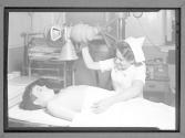 [Nurse with Boy, T.B. Lamp]