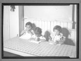 [Three Children at a Table]