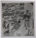 [Children in front of a pile of wood planks]