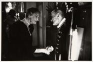 Old man and woman shaking hands, Deauville, France