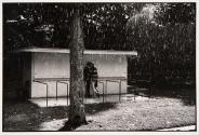 Couple under awning during heavy rain, Deauville, France