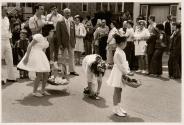 [Flower girl in wedding tying her shoe]