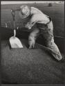 Our daily bread: Farmer shoveling wheat from wagon, Centralia, Kansas