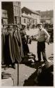 [Man trying on coat]