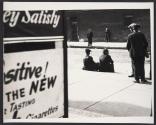 [Men sitting on curb]
