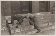 [Men asleep on steps]
