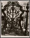 [Gate in front of tombstone]