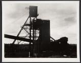 [Factory in silhouette]