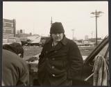 [Man wearing hat and pea coat]