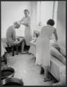 [Women washing men]