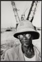 [Man wearing hat and sunglasses, Guinea]